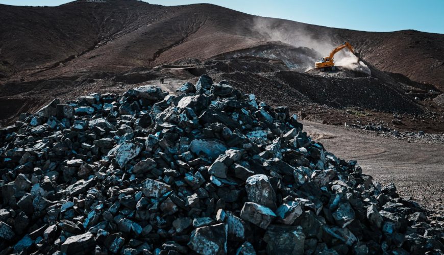 Afghanistan lithium mining site with excavator in operation