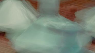 Whirling dervishes performing Sufi dance in honor of Mawlana Jalal al-Din Rumi