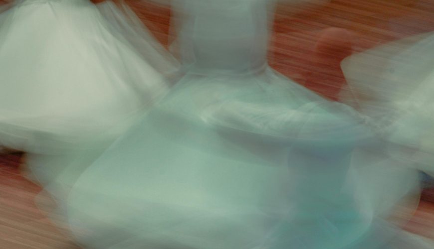 Whirling dervishes performing Sufi dance in honor of Mawlana Jalal al-Din Rumi